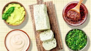 Colorful assortment of dips and spreads: green avocado, creamy tahini, herb-infused butter, spicy condiment, and vibrant salsa